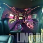 Luxurious black leather wraparound seating and bar inside Norfolk’s 14-passenger SUV limo.