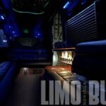 Interior view of the Mercedes Sprinter 15-passenger party bus with mood lighting and a custom-built bar area.