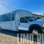 Front view of the Ford 25-passenger party bus, offering spacious and comfortable travel for mid-size groups.