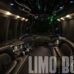 Night view of the 25-passenger Ford party bus with glowing LED ceiling and wrap-around leather seating.