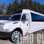 Angled front view of a luxury 30-passenger party bus, ideal for stylish group transportation in Norfolk and nearby regions.