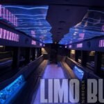Dynamic purple and blue LED ceiling inside 50-passenger party bus with leather seating and luxury finishes for Norfolk celebrations.