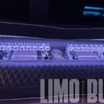Modern built-in bar and cup holders with LED lighting inside a 50-passenger party bus for premium Norfolk event experiences.